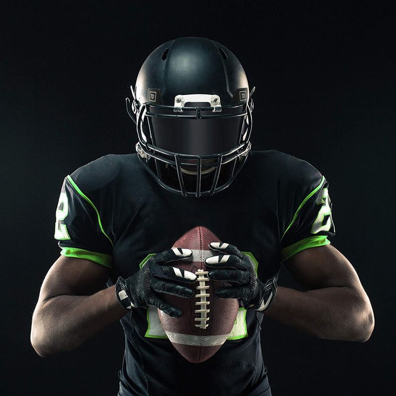 Football player wearing a clear visor on a practice field