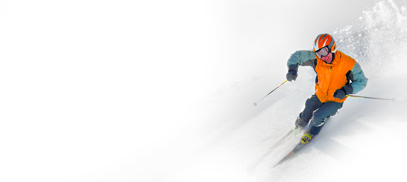 Skier wearing colored lens goggles in variable mountain conditions